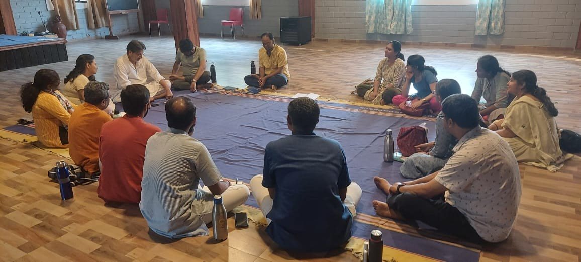 Retreat participants seated in a circle for a dialogue session